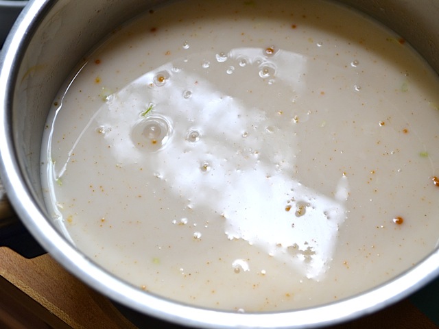 coconut milk and water added to pot of lentils 