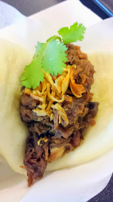 Pok Pok Wing at the PDX airport offers Mantou, or Chinese Steam Buns, these here are filled with Muu Waan, this is a sweet and savory pulled pork with fried shallots and cilanto on the steam bun