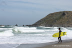 A surfer watching tides at Pacifica State Beach