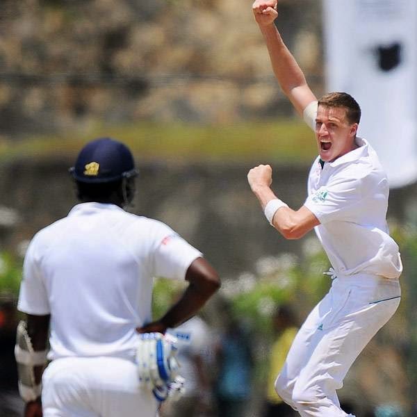 South African cricketer Morne Morkel (R) celebrates after dismissing Sri Lankan batsman Dinesh Chandimal during the final day of the opening Test match between Sri Lanka and South Africa at the Galle International Cricket Stadium in Galle on July 20, 2014.