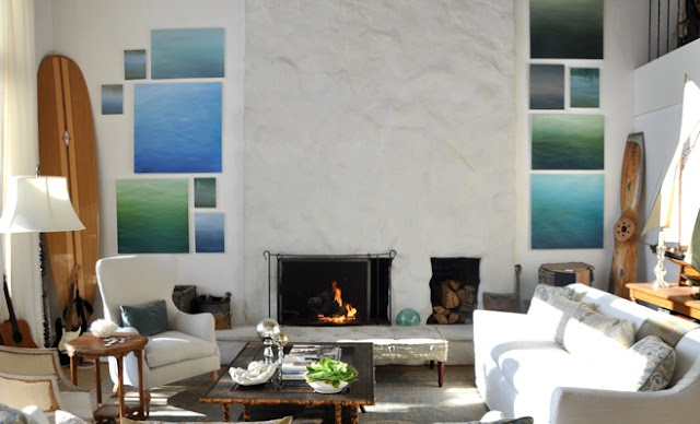 Pictures of the ocean flanking a fireplace.