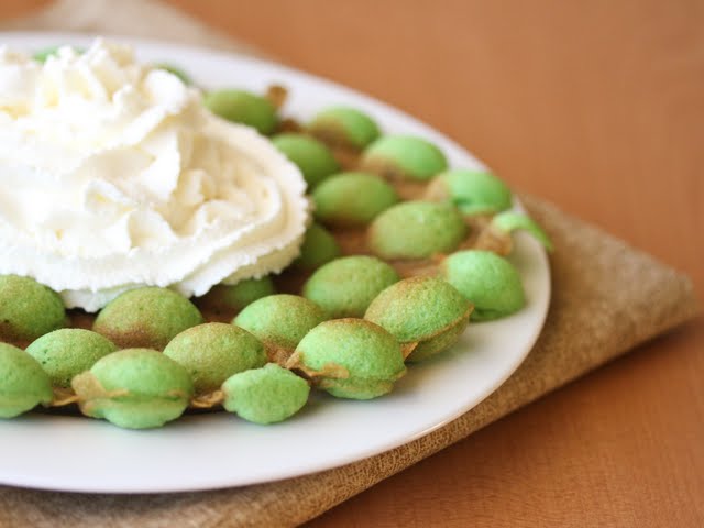 photo of Pandan Flavored Egg Puffs topped with whipped cream