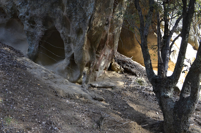 barbed wire across a sandstone arch