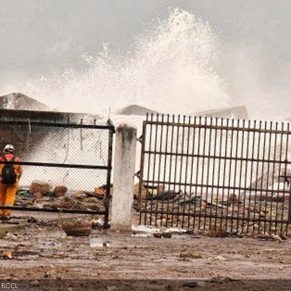 Waves crash onto the shore at a fishing harbour in Visakhapatnam district