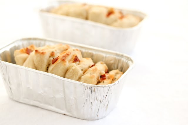 photo of a Pizza Pull Apart Bread in a loaf pan with another one in the background