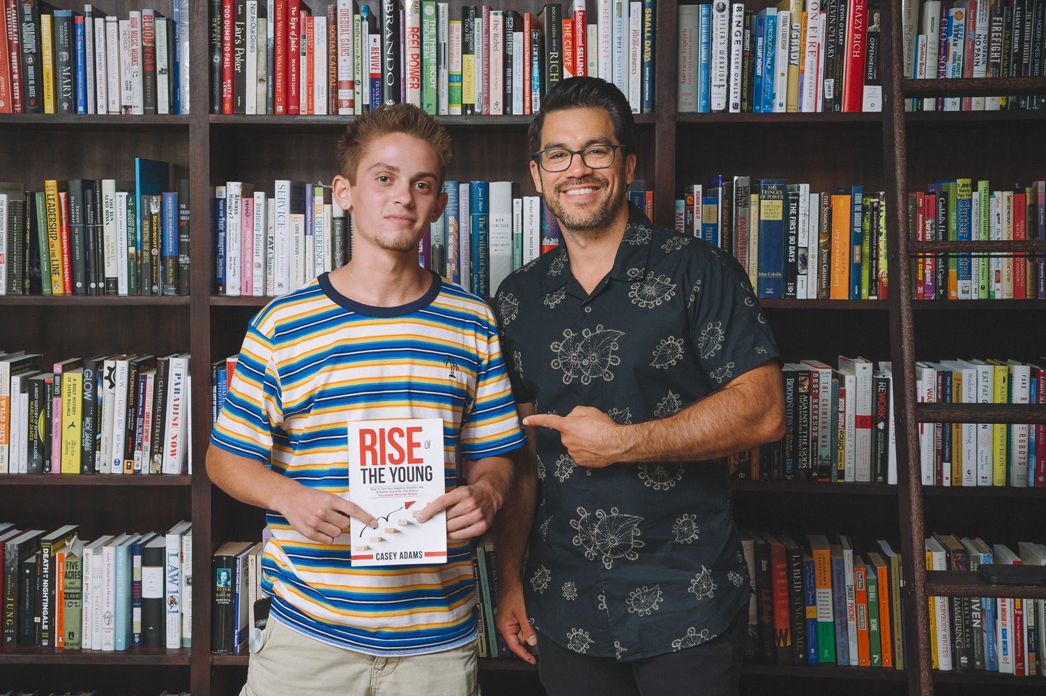 Casey Adams holding a book