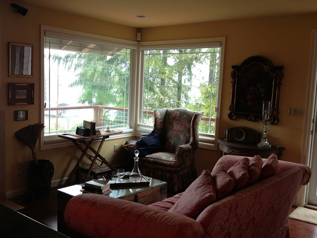 A cozy livingroom with antiques and view overlooking Taylor Bay in Longbranch, Washington.
