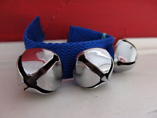 closeup of a blue bracelet covered with jingle bells