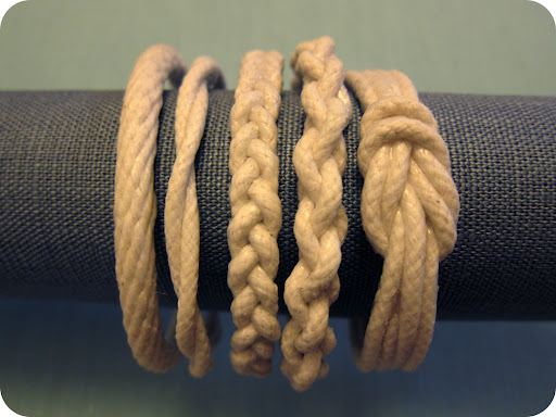 Twist, braid or knot rope in the design you prefer. Loop your design to make sure the inside diameter measures about 2 1/2 inches (small), 2 5/8 inches (medium), or 2 3/4 inches (large). Twist, braid or knot rope in the design you prefer. Loop your design to make sure the inside diameter measures about 2 1/2 inches (small), 2 5/8 inches (medium), or 2 3/4 inches (large).