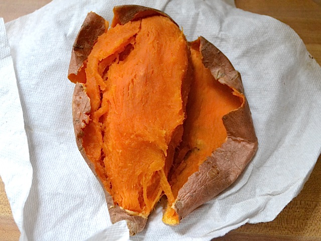 cooked sweet potato, peeling the skin off 