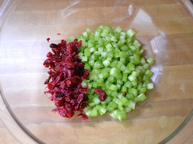 cranberries and celery diced into small pieces and placed in mixing bowl 