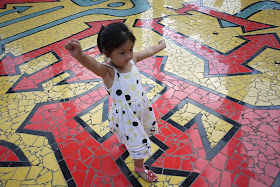 little girl on tiled ground covered with numerous arrows