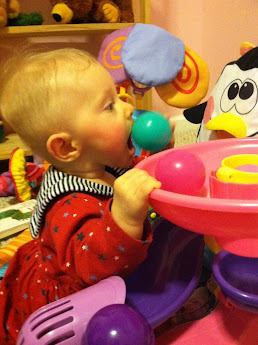 Baby eating toy ball