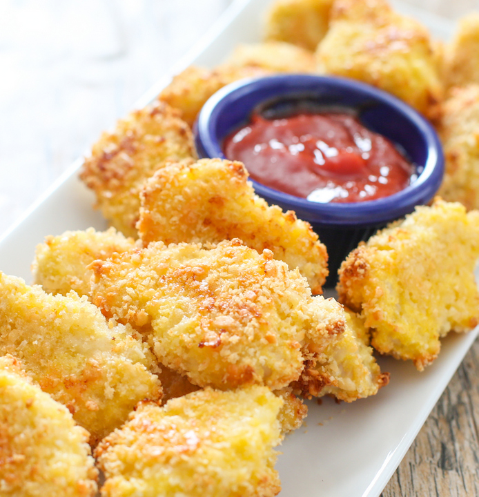 photo of Parmesan Chicken Nuggets on a white serving plate with dipping sauce