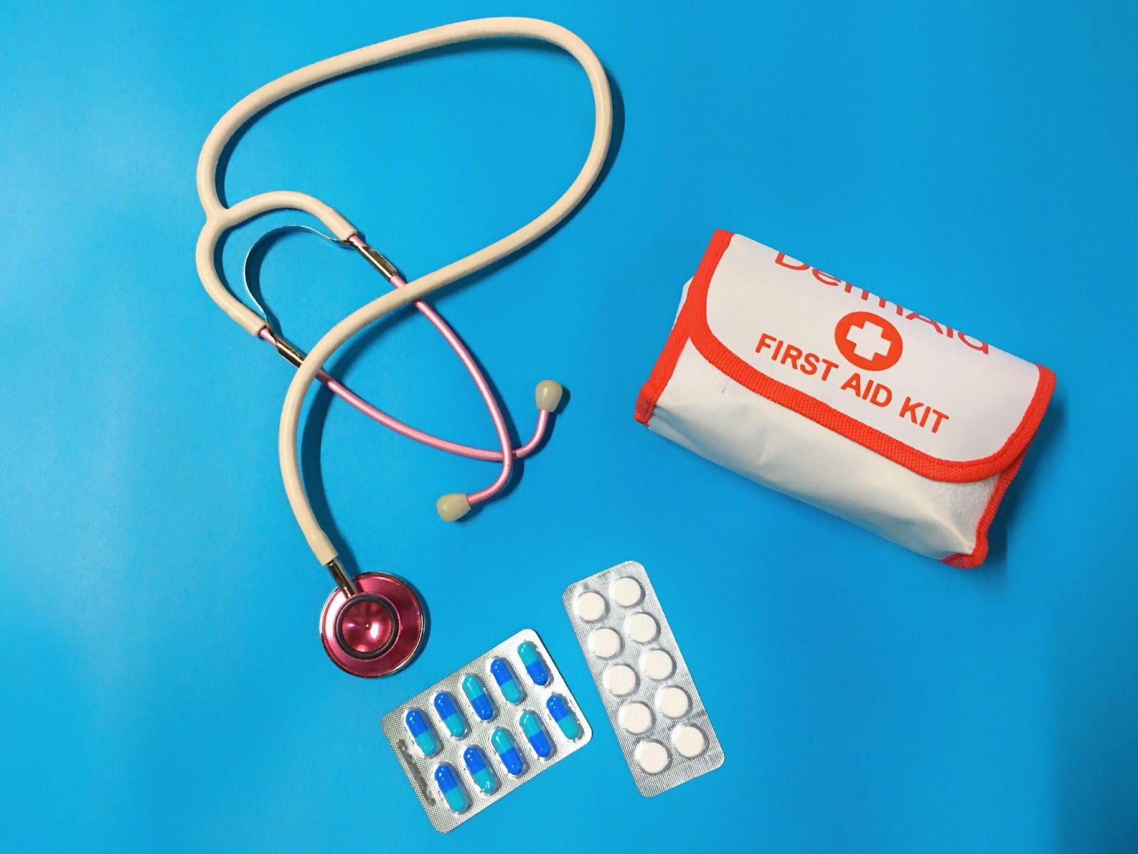 a stethoscope, a first aid it and some two strips of capsule are travel essentials