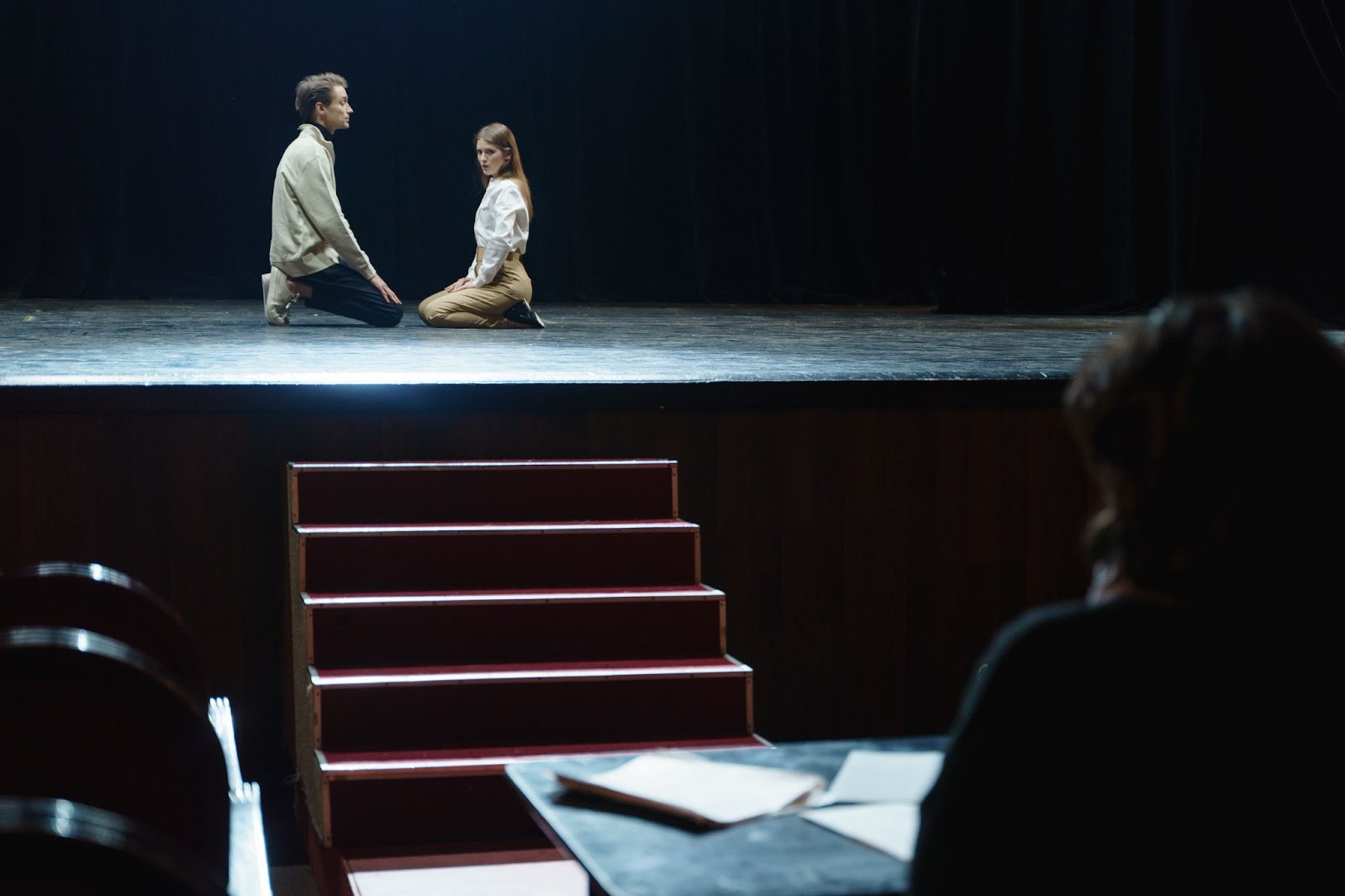 Two people are rehearsing lines on a musical stage theatre.