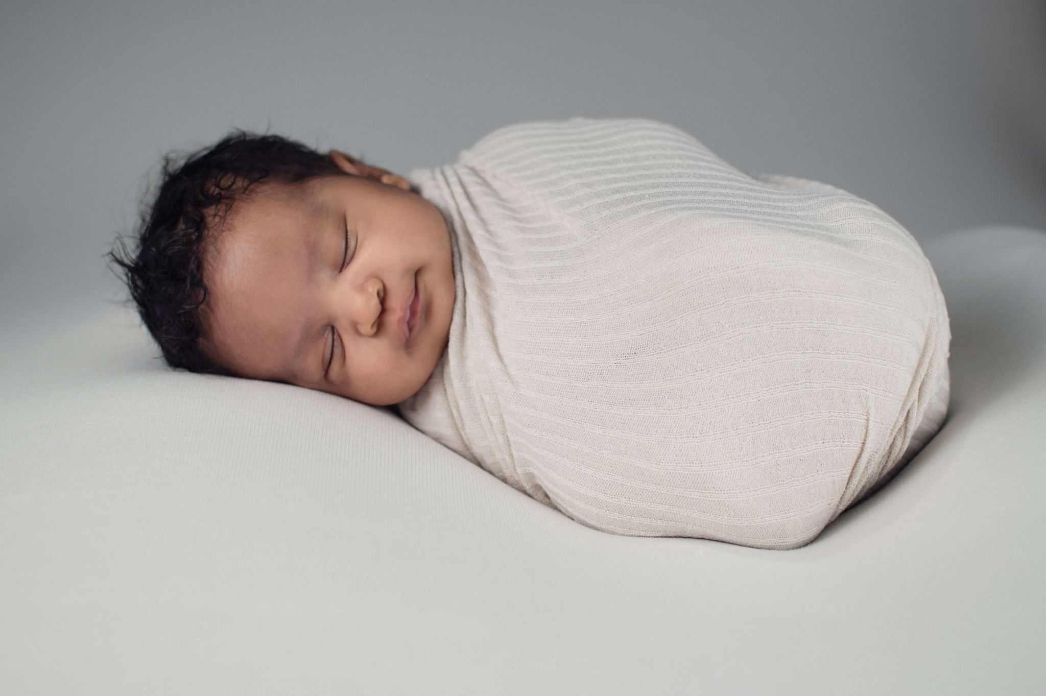 Where should a newborn sleep at night