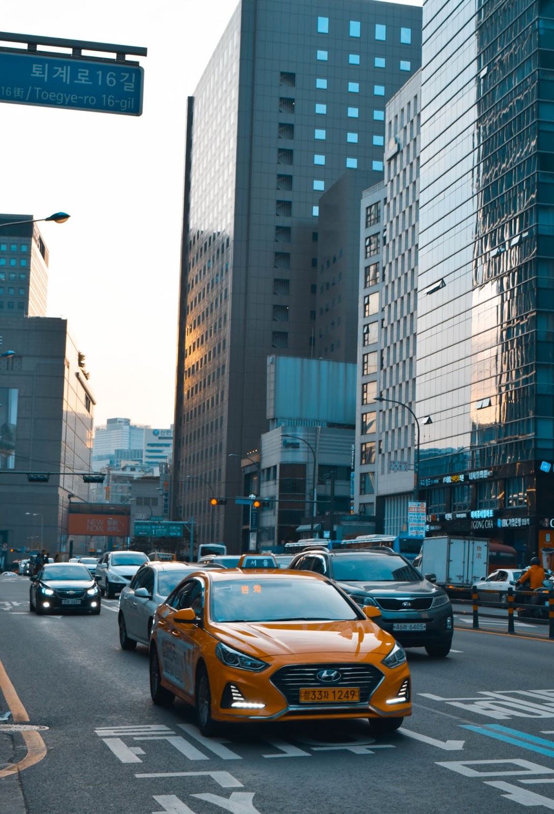 An image of an orange taxi on the streets of Seoul.