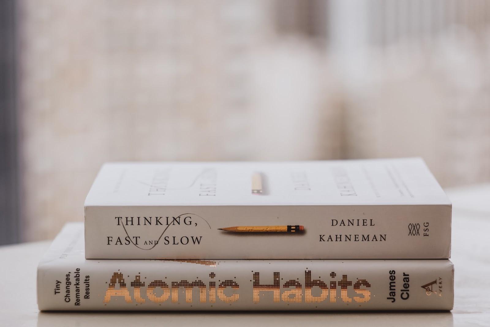 Atomic Habits by James Clear; Thinking Fast and Slow by Daniel Kahneman