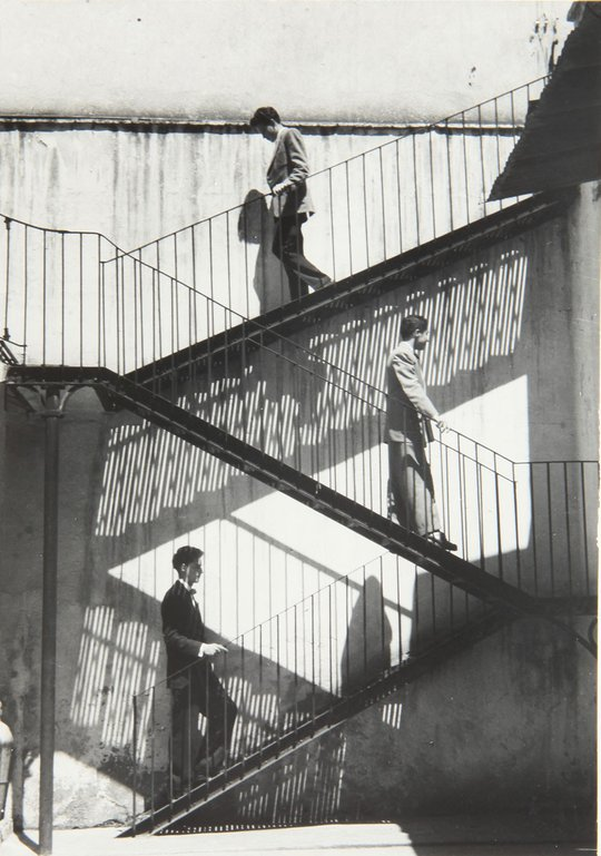 3 men on stairs: 2 descending, 1 ascending