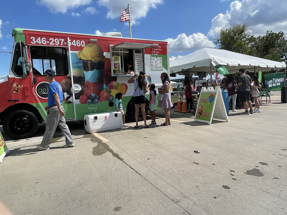 A food truck with people standing in front of it

Description automatically generated