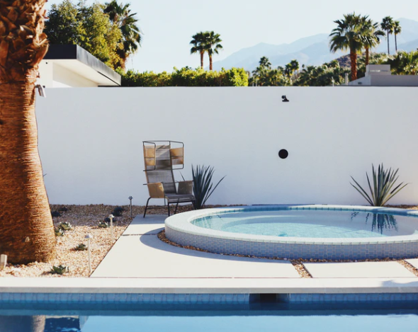 tall tree and chair besides big and small circular pool