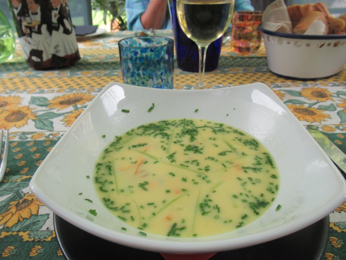 A bowl of soup on a table

Description automatically generated