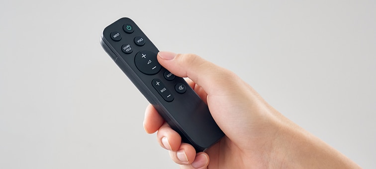 Image of a hand operating a remote control