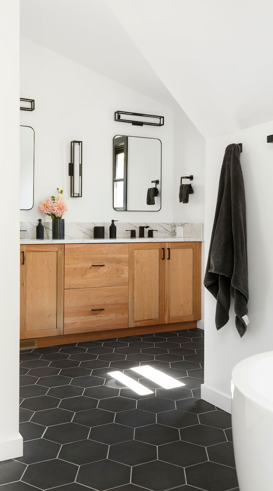 modern twist using contrasting tile color and shape in small bathroom
