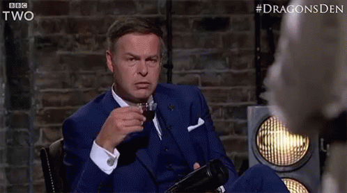 A gif of Peter Jones from Dragons Den looking serious as he sips some tea. The camera pans in slowly on him. 