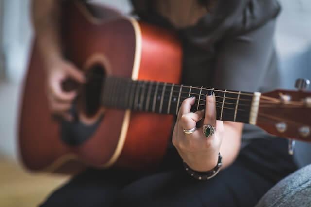 A photo of a person playing a guitar