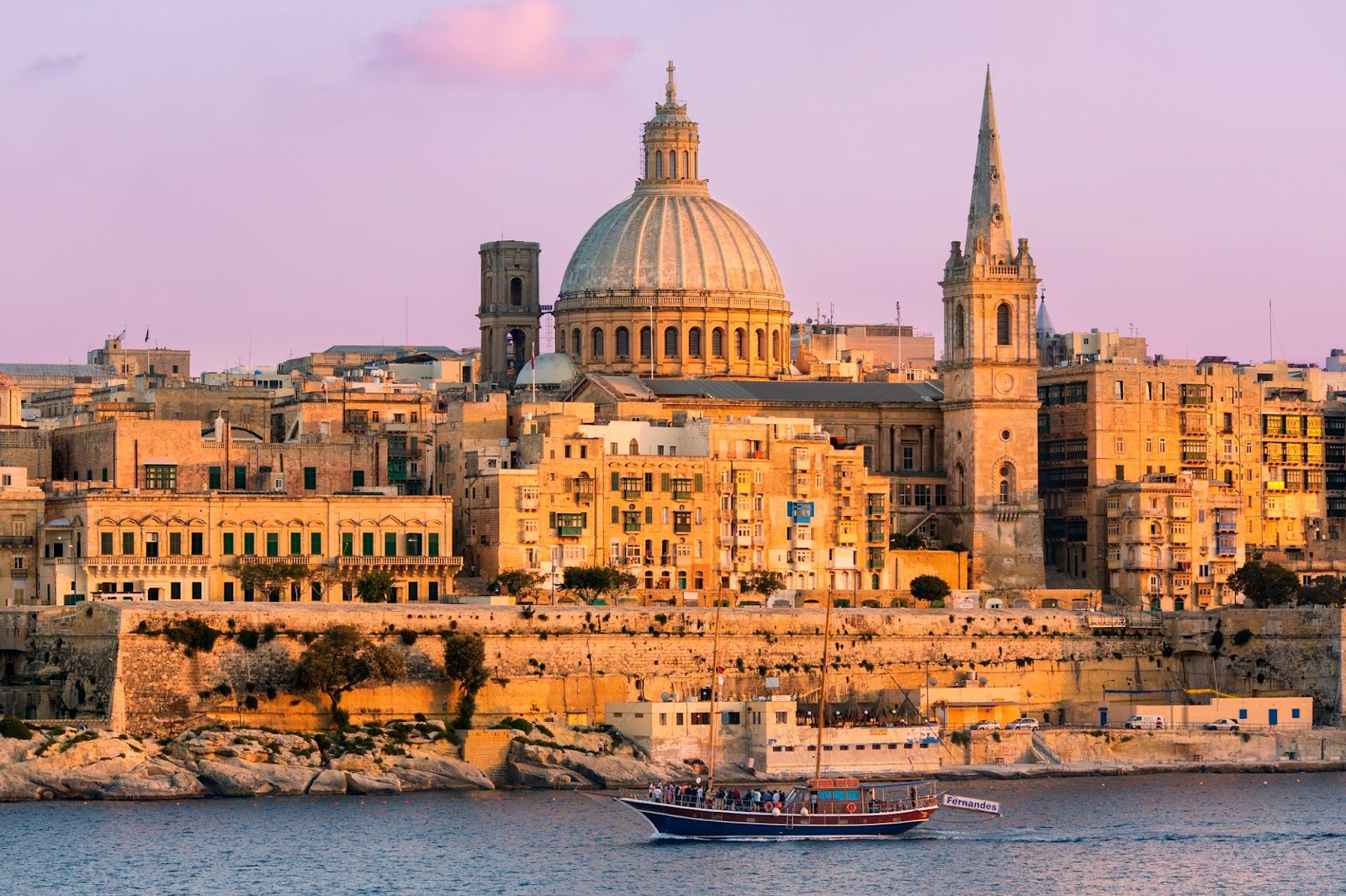 The harbourfront in Valletta, the capital city of Malta, with its distinctive tan coloured buildings