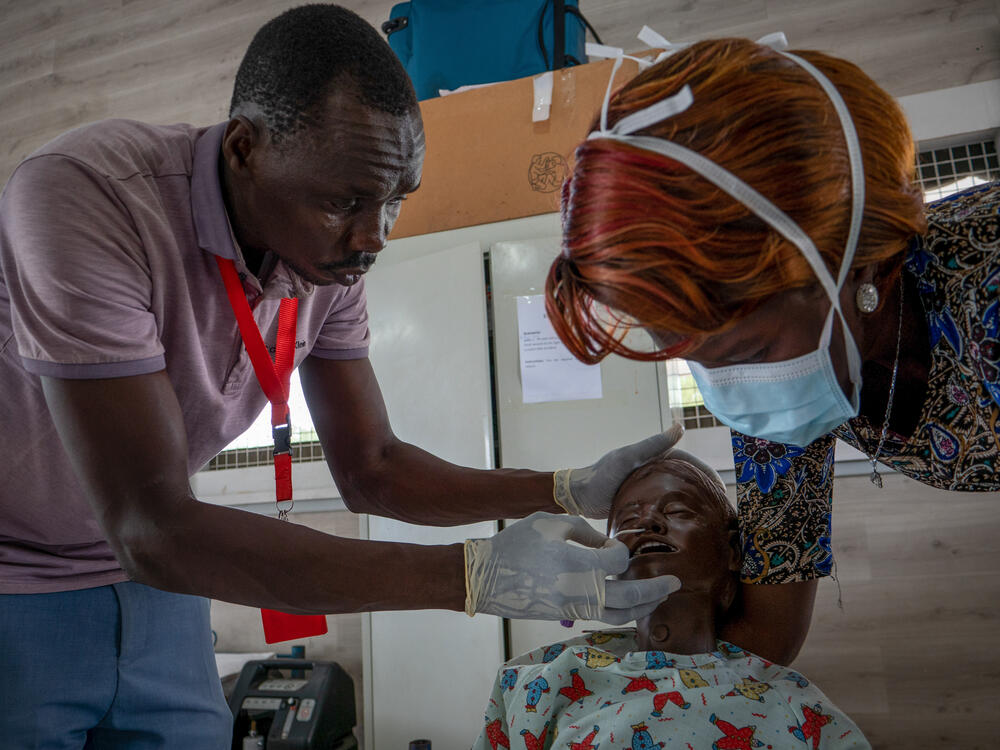 During a training session, nursing students Gatjang Thiep and Tabitha Nyayual insert a nasal catheter into a child medical mannequin