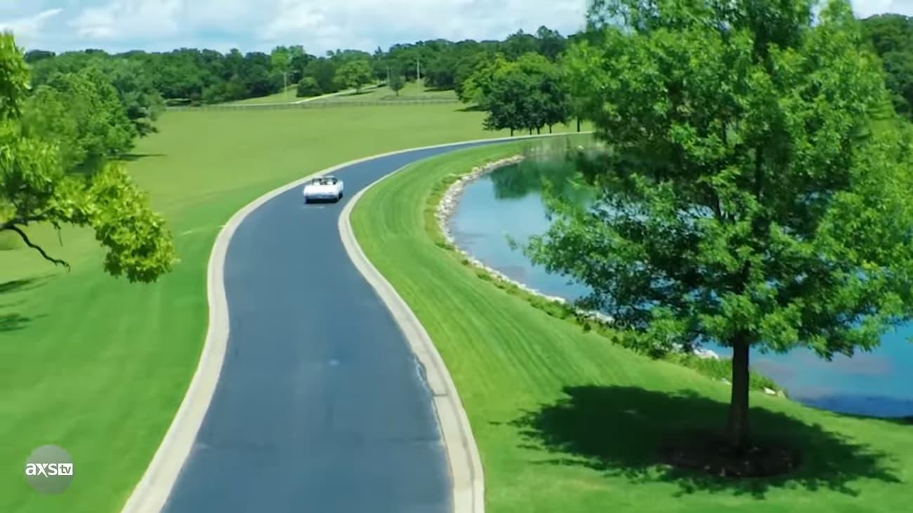 A car driving on a road next to a body of water

Description automatically generated with medium confidence