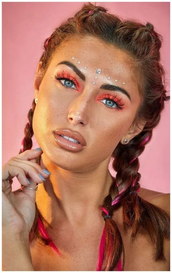 Woman with makeup wearing face jewelry