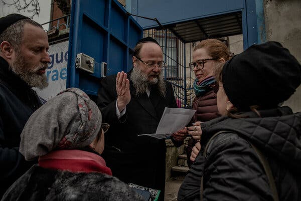 Pinhas Zaltzman, chief rabbi of Moldova, helping sort out the papers Jewish refugees from Ukraine will need to board planes taking them to Israel.