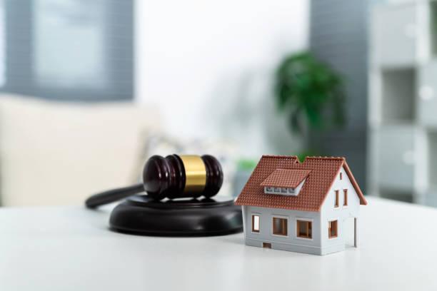 Model house and gavel on the table Model house and gavel on the table. property solicitor stock pictures, royalty-free photos & images