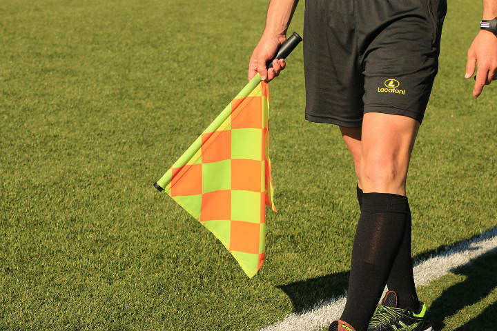 soccer assistant referee holding flag
