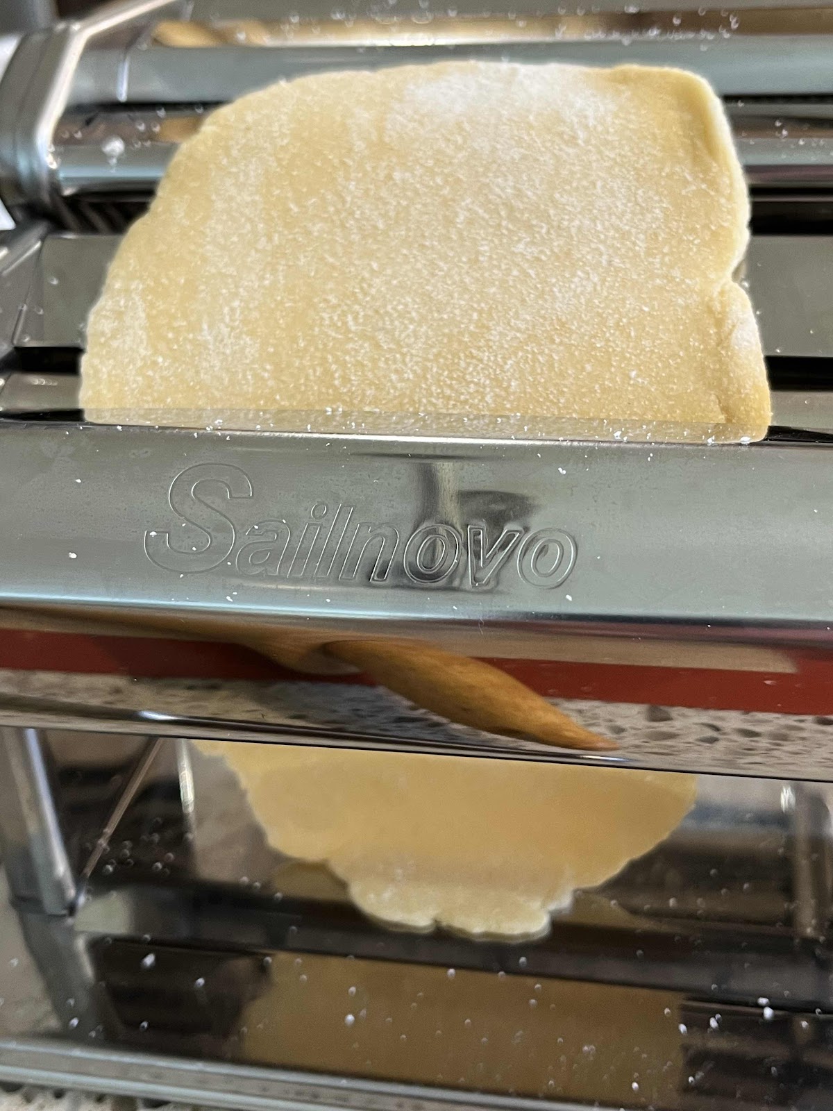 Run the dough through the rollers of the pasta maker