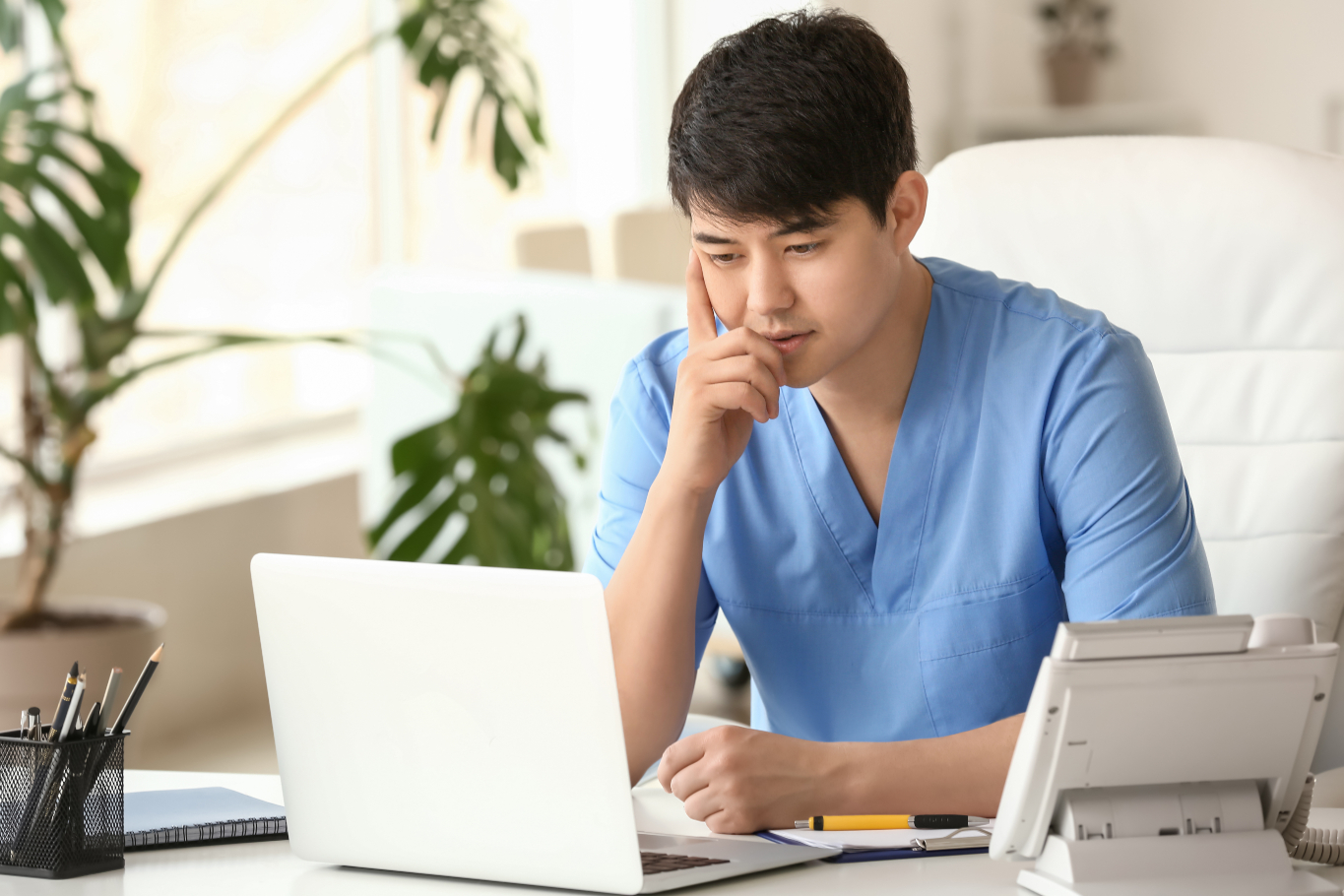 KPMG internship: Man thinking infront of a laptop