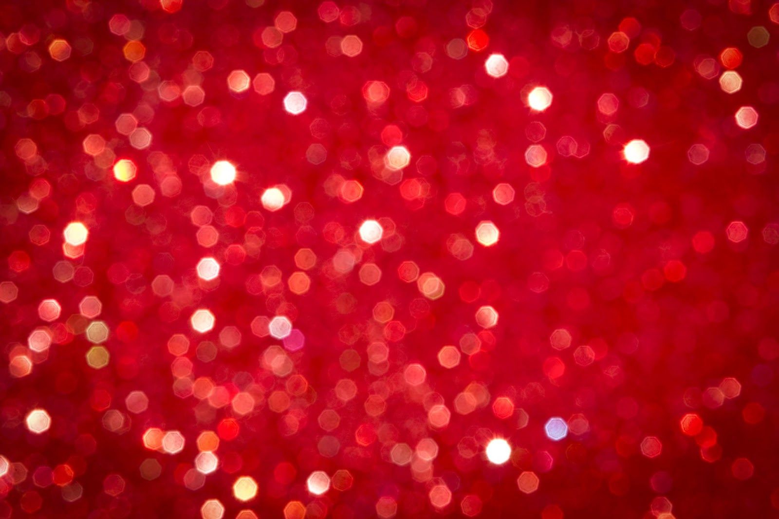 Defocused abstract red Christmas lights on red background