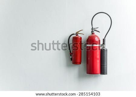 Two fire extinguishers on a white background