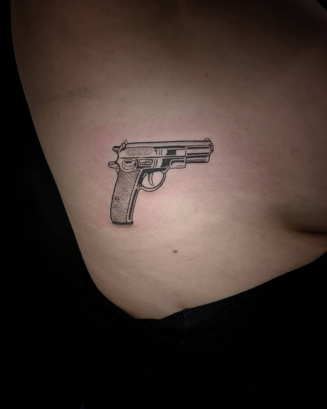 Grey Ink Gun Tattoo