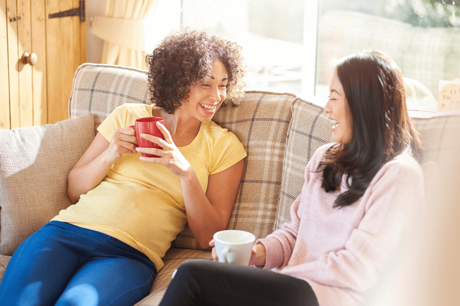 Pregnant woman having tea with her friend