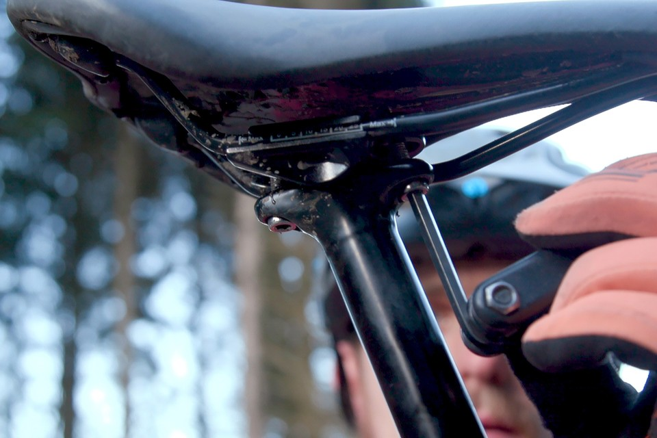 Start loosening the bolts of your old mountain bike saddle so that you can install the replacement seat.