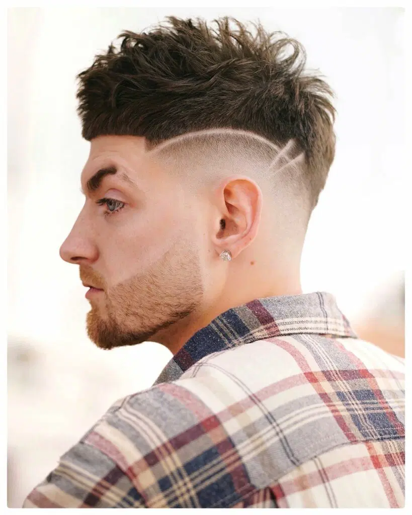 Side view of a guy showing off his designed hair