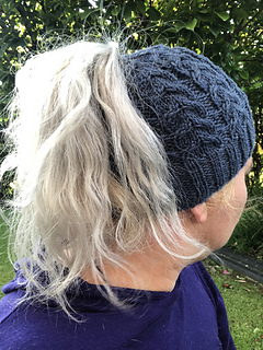woman wearing knitted ponytail beanie outside