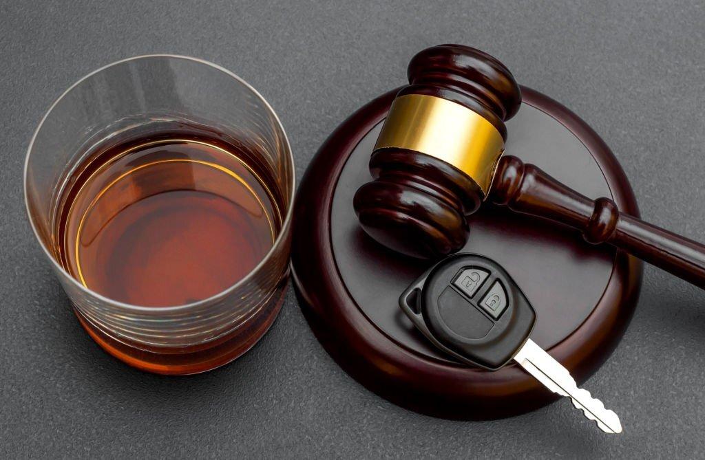 A gavel and a glass of alcohol Description automatically generated with medium confidence