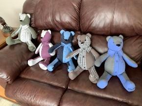 A group of stuffed animals on a couch

Description automatically generated with medium confidence