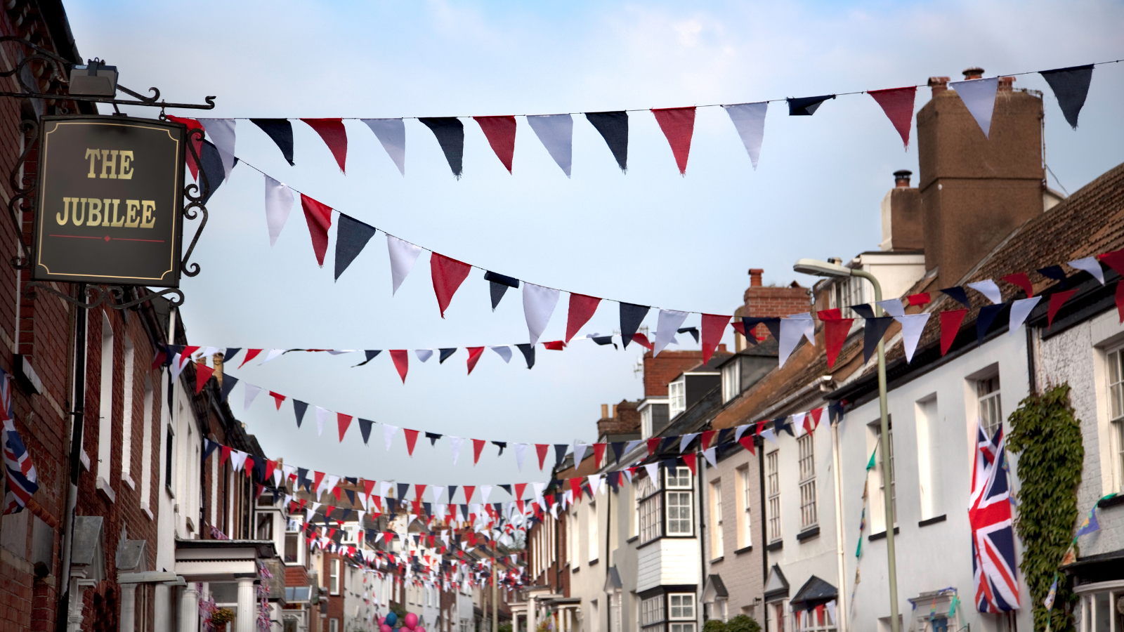 Street with red, white and blue bunting and sign for ‘The Jubilee’